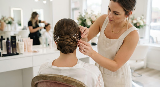 Stylist carefully pinning a hairstyle