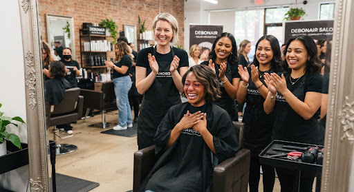 Salon team celebrating with a client