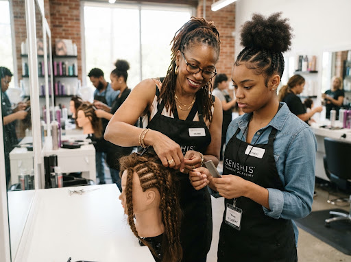 Stylist guiding a learner through hands-on hair styling