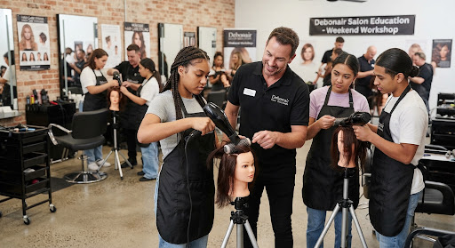 Beauty trainees practicing together in a salon workshop